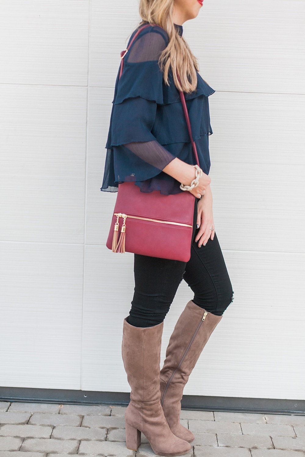 love the details of this outfit - navy ruffle blouse with boots