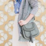 floral cami, pleated skirt, long cardigan, and saddle bag