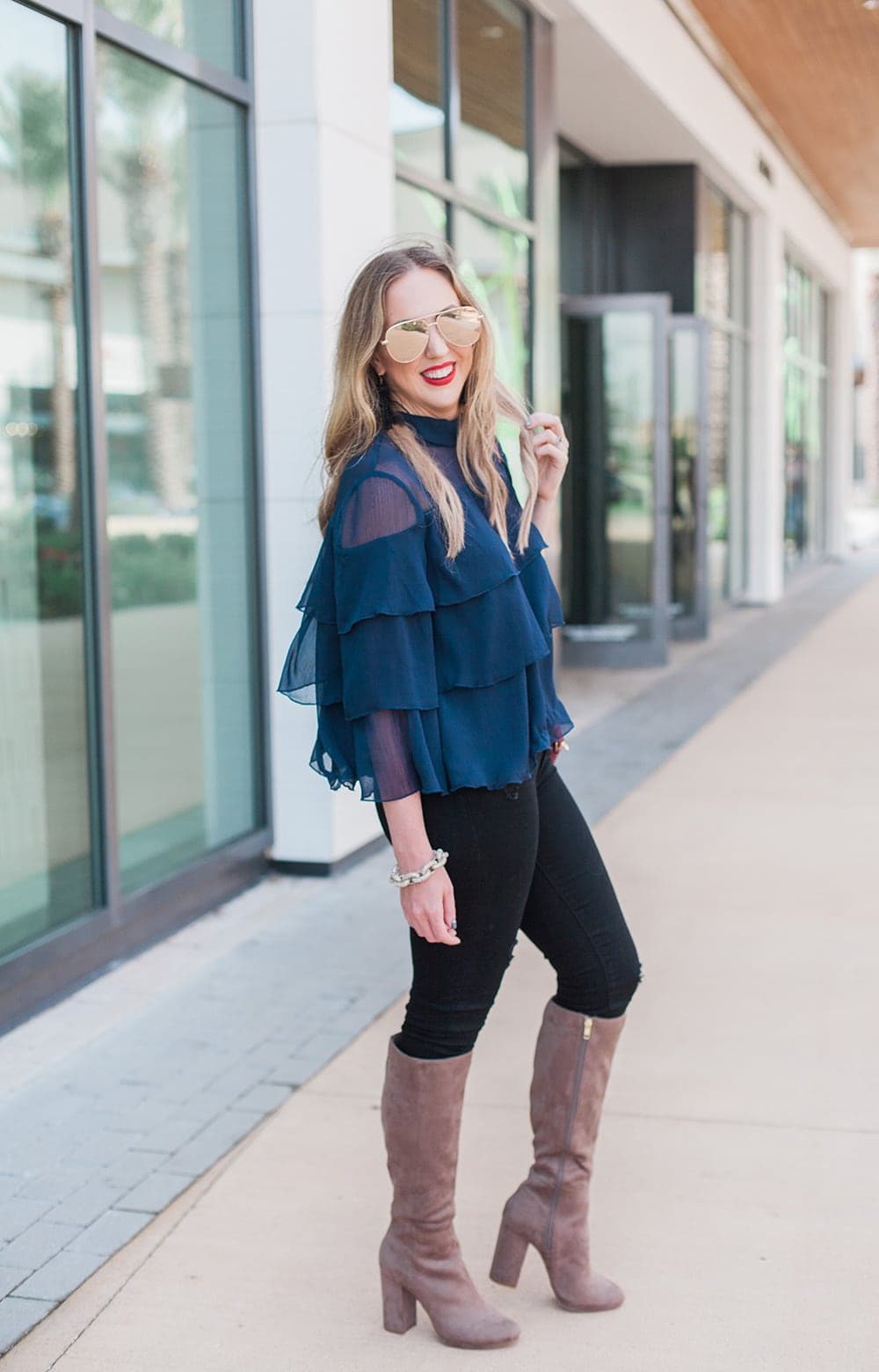 love this fall and holiday outfit! ruffle blouse with tall boots