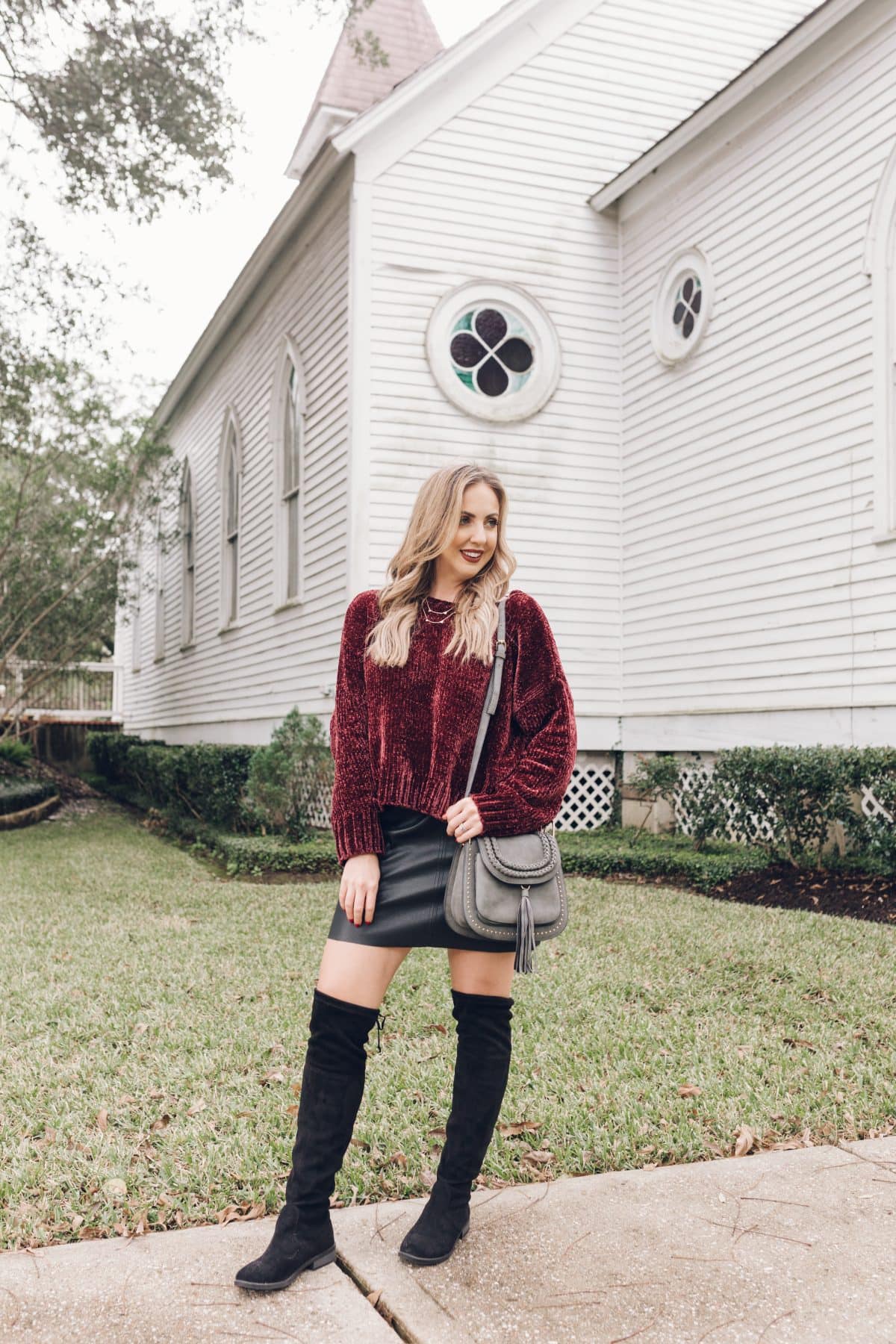 Houston lifestyle blogger Meg O. on the Go shares a holiday outfit that includes a chenille sweater, faux leather skirt, and over the knee boots - all from Evereve