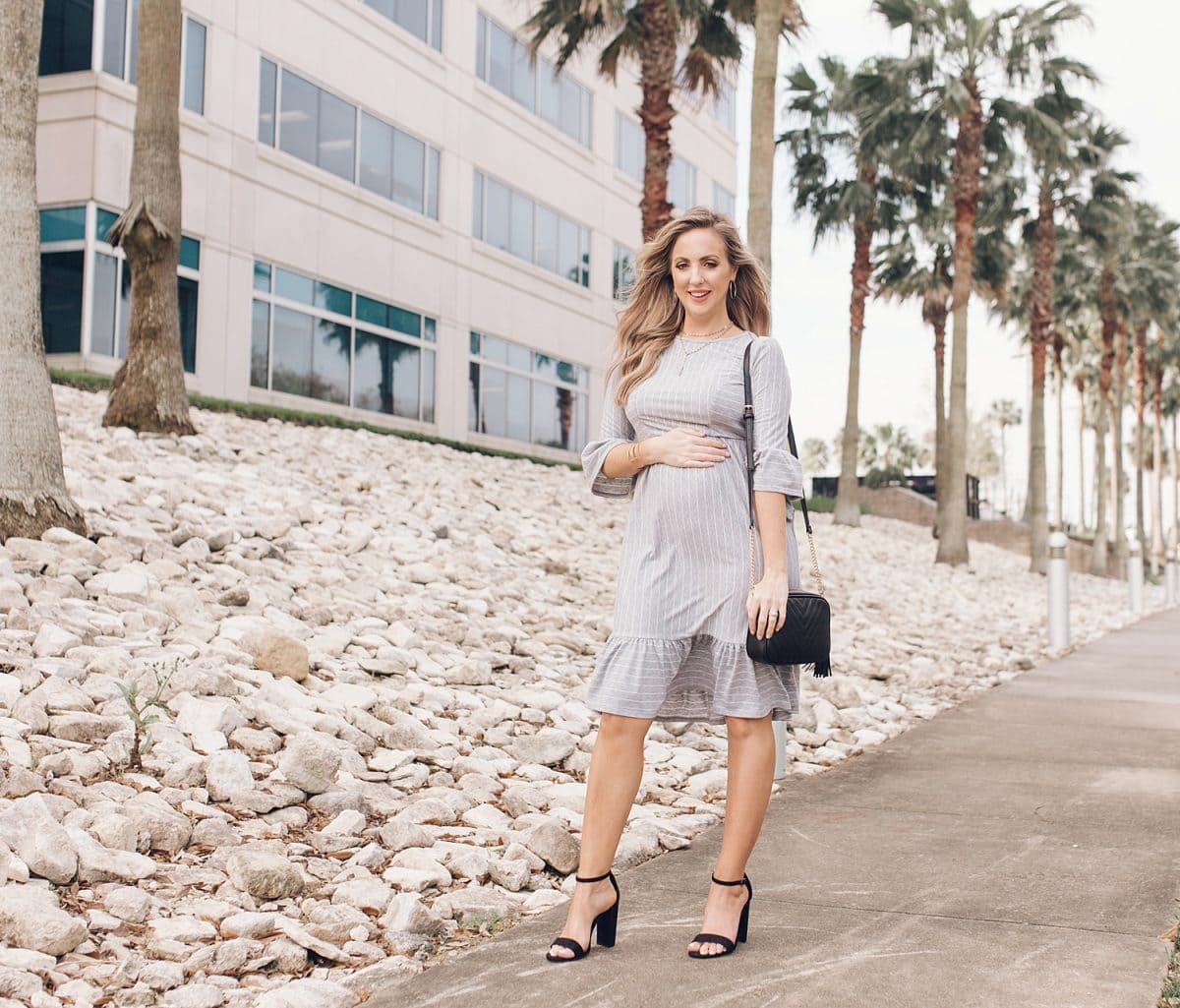 Houston lifestyle blogger Meg O. on the Go shares her favorite spring maternity dresses - this grey striped ruffle trim dresss with 3/4 sleeves is perfect for spring!