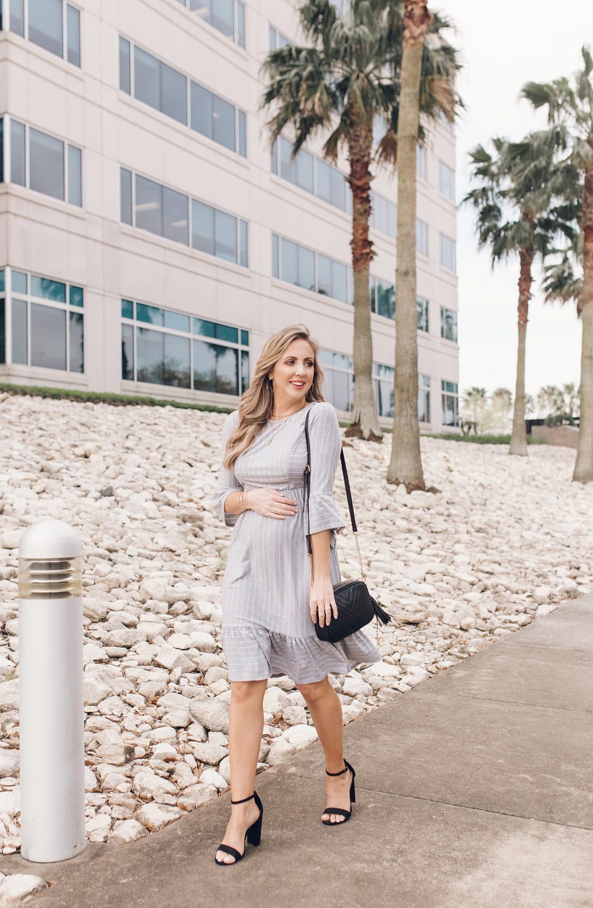 Houston lifestyle blogger Meg O. on the Go shares her favorite spring maternity dresses - this grey striped ruffle trim dresss with 3/4 sleeves is perfect for spring!