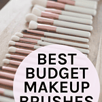 A collection of neatly arranged makeup brushes with soft white bristles and rose gold handles on a wooden surface with the words "Best Makeup Brushes for Beginners"